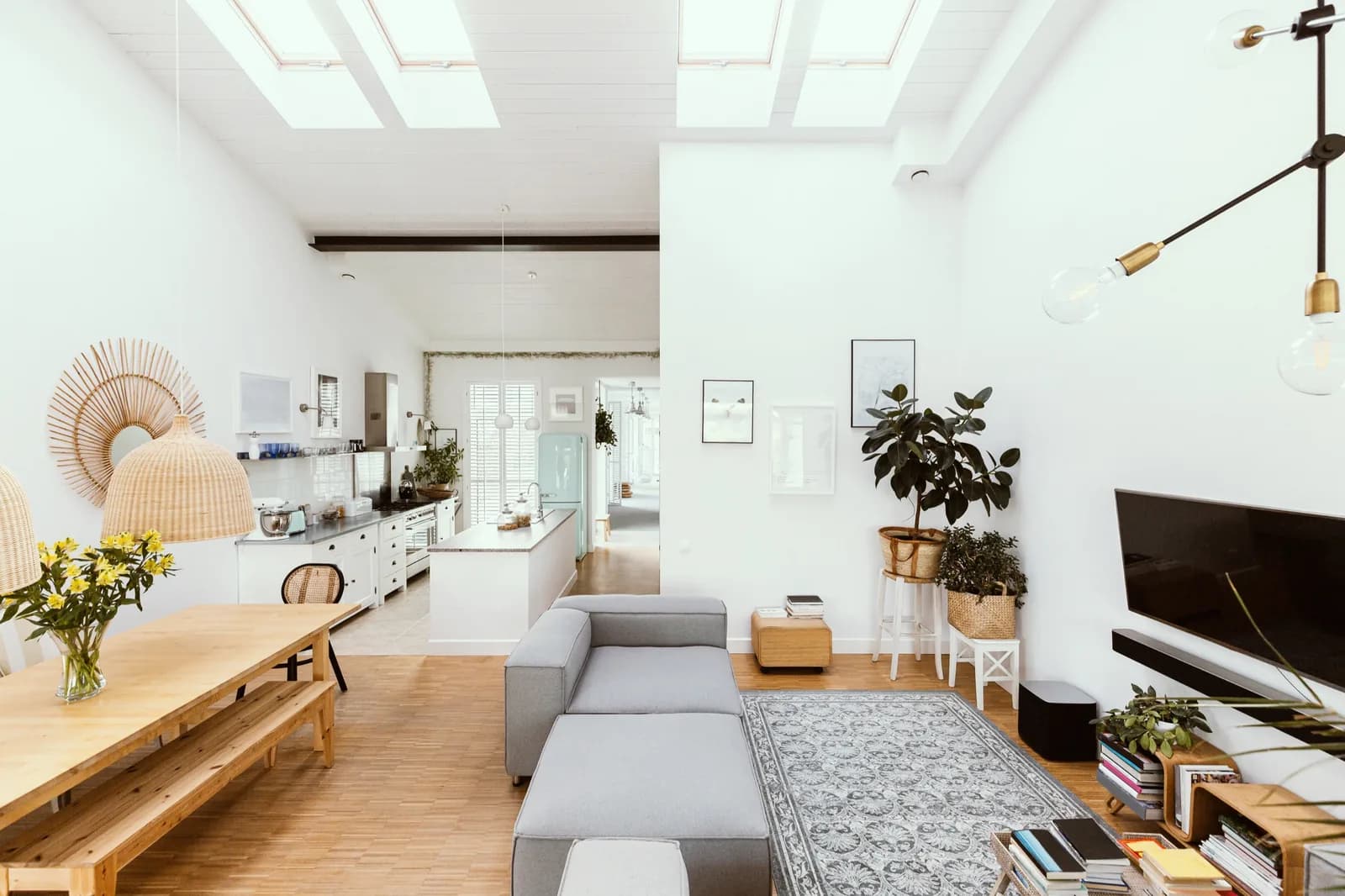 Open living room and kitchen lit by skylights