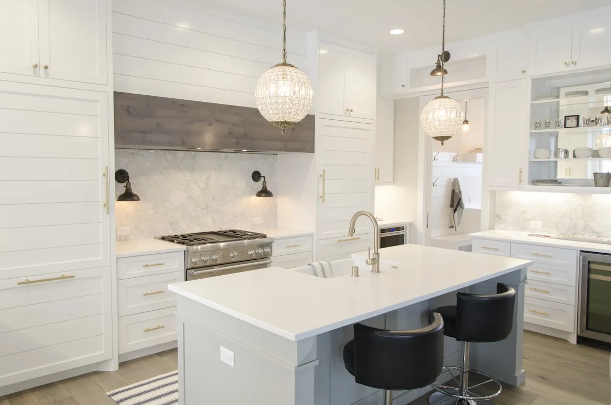 White kitchen with an island and pendant lights
