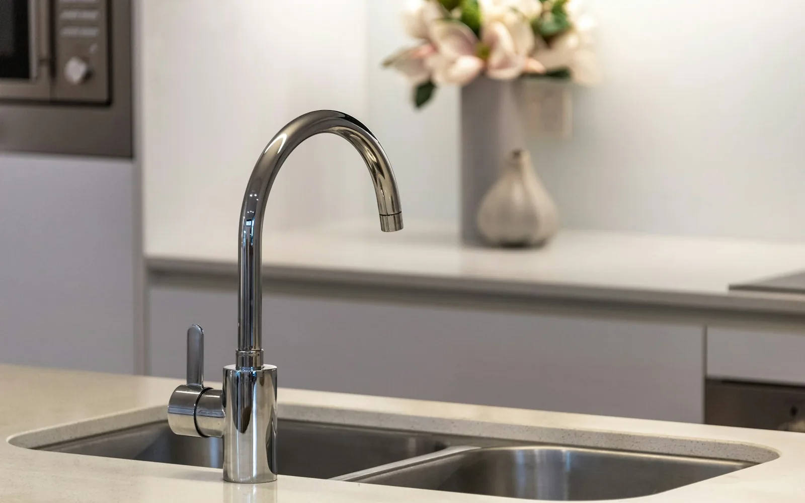 Chrome pull-down faucet over a stainless double kitchen sink